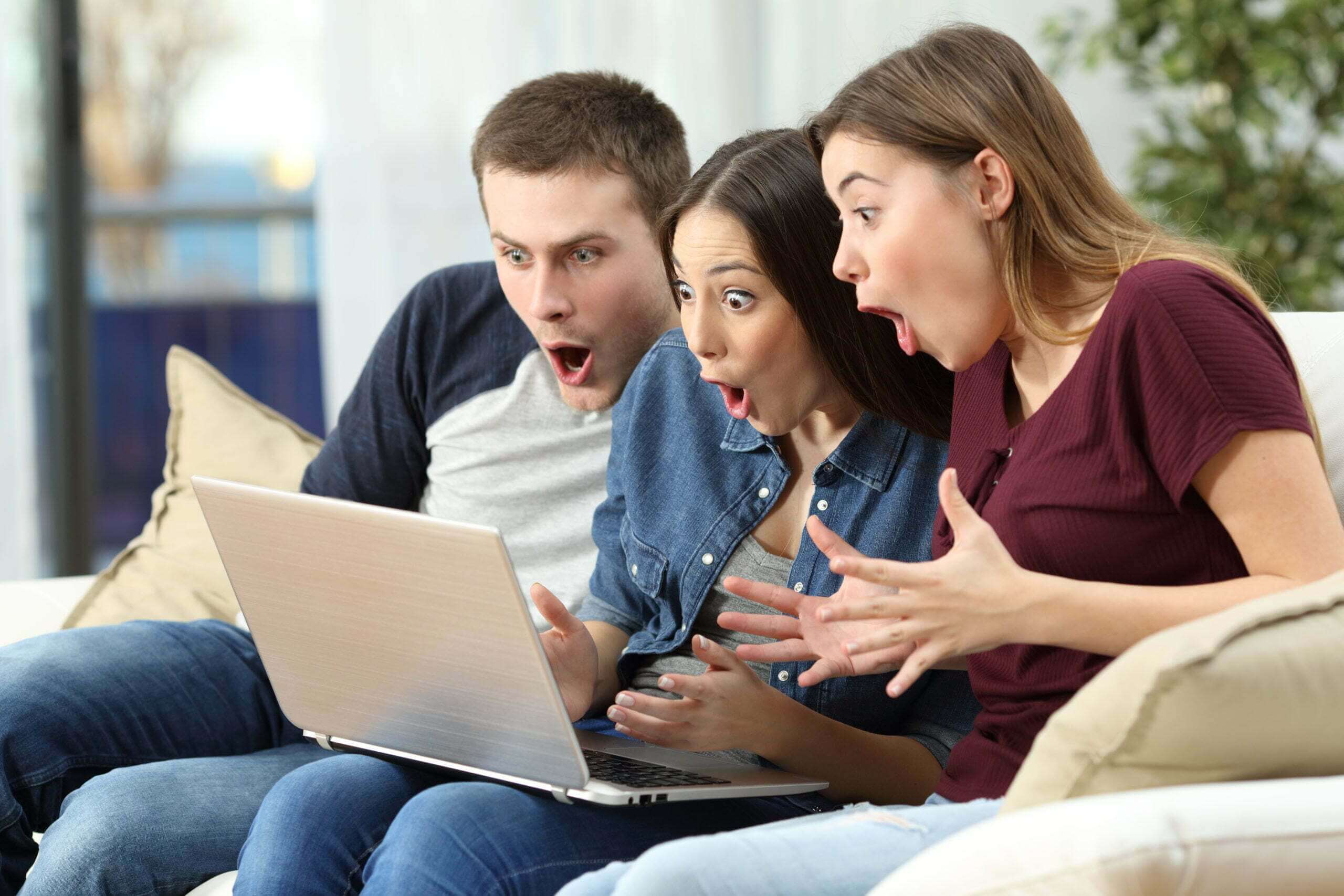 friends looking at at content on computer, amazed faces