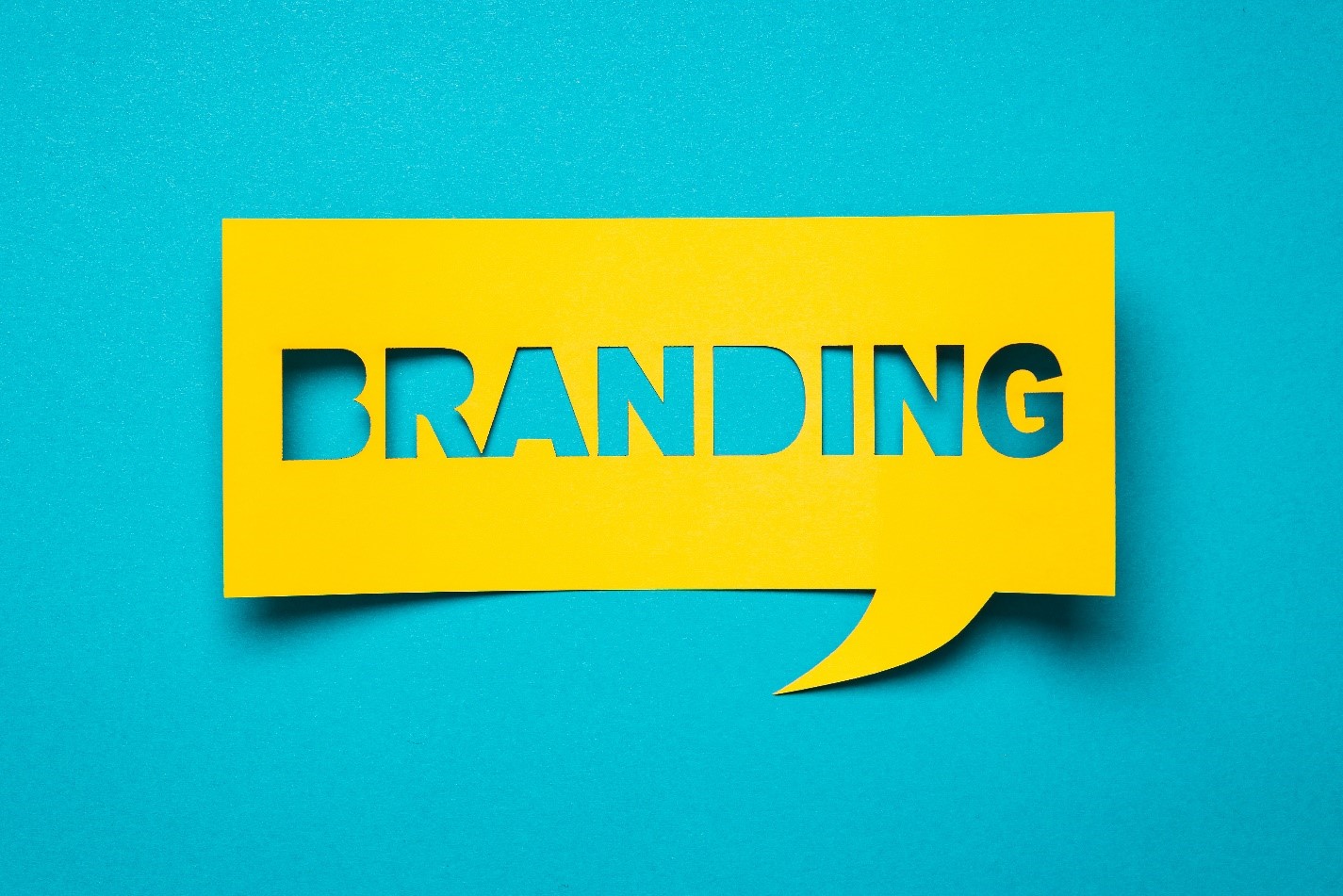 the word "Branding" cut out of yellow paper