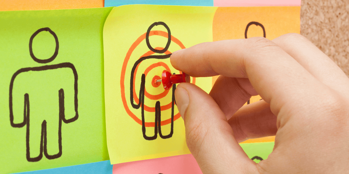 Sticky notes with drawings of people and a target on the middle